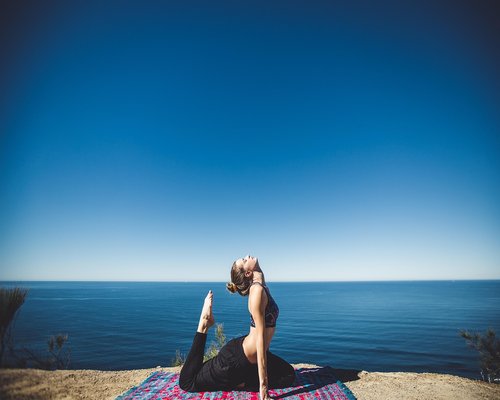 Woman practicing gentle yoga stretching outdoors